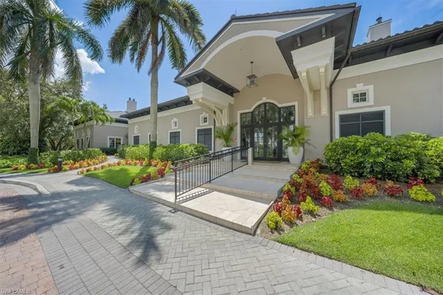 a living room with furniture a flat screen tv and kitchen view