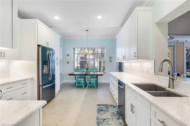 a kitchen with granite countertop a sink appliances and cabinets