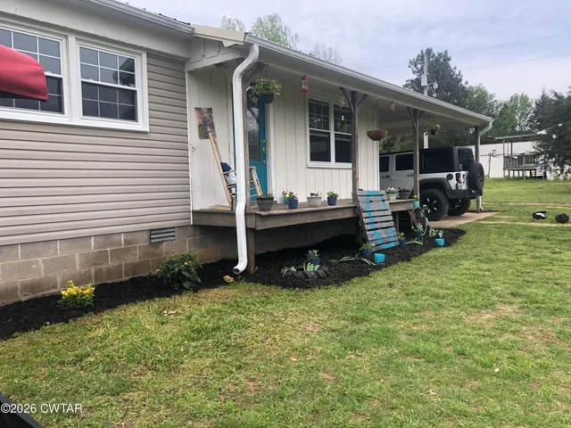 a view of house with backyard porch and sitting area