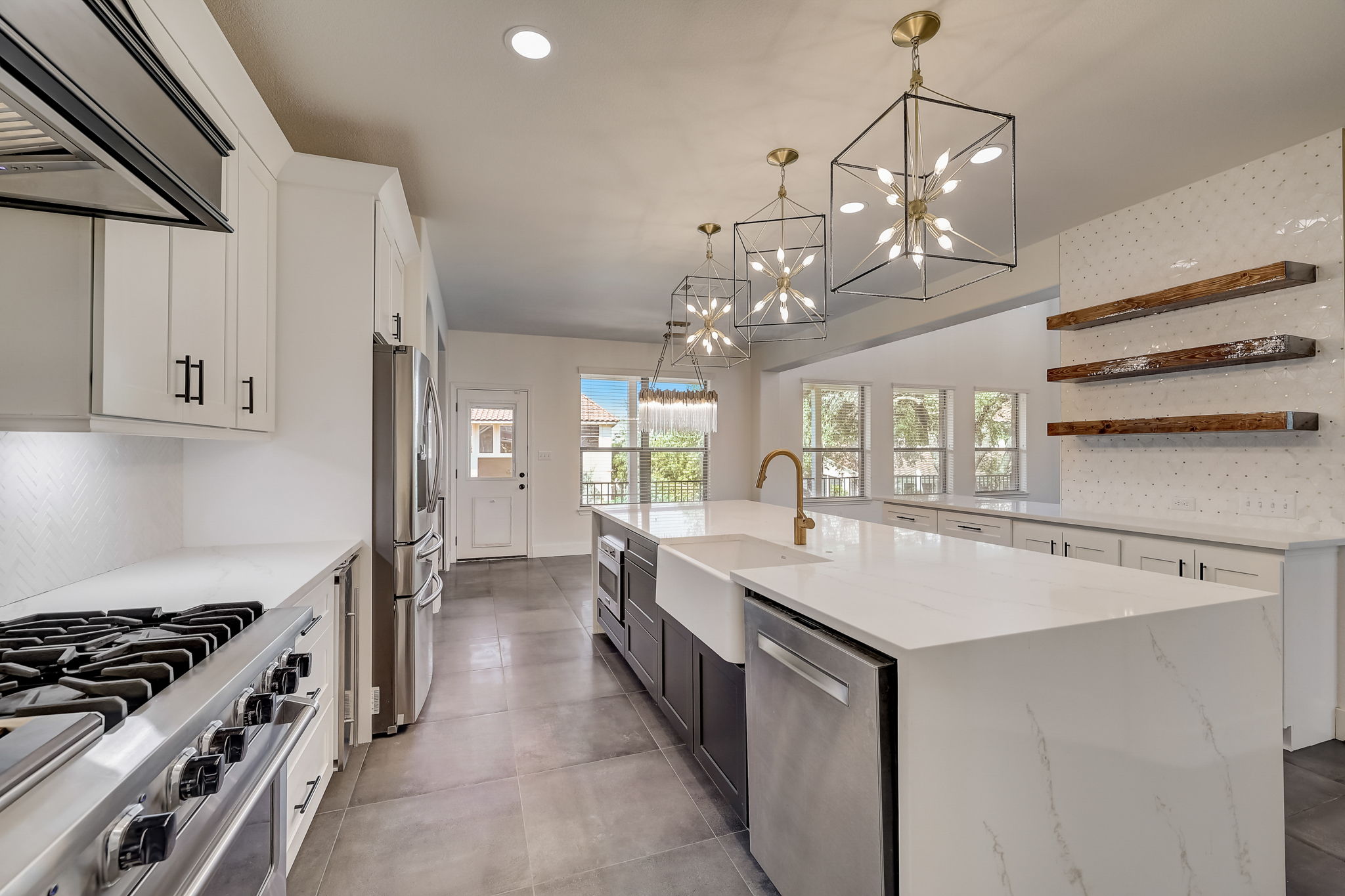 16012 Spillman Ranch Loop Austin, TX 78738 - Photo 17 of 38 Culinary delights await in this bright kitchen, complete with a sprawling island and abundant counter space.