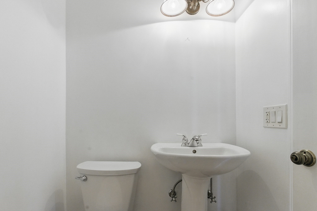 25 Sandra Road Peabody, MA 01960 - Photo 15 of 41 a bathroom with a sink a toilet and mirror