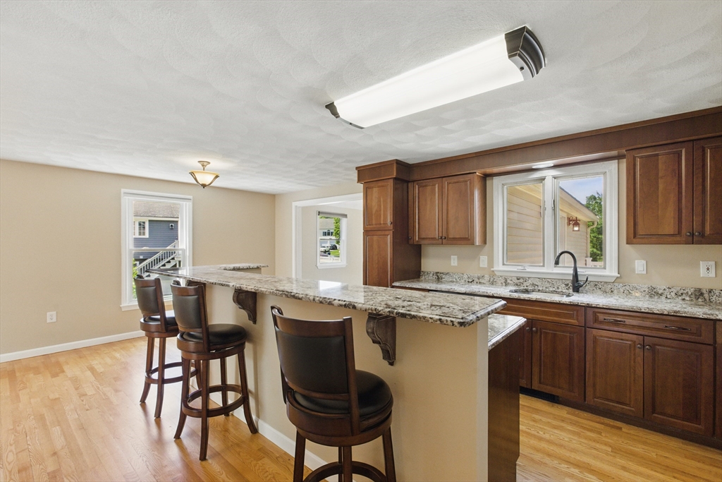 25 Sandra Road Peabody, MA 01960 - Photo 22 of 41 a kitchen with a sink and chairs