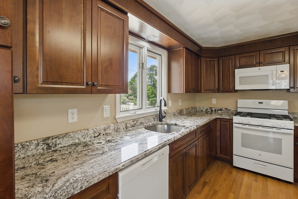 25 Sandra Road Peabody, MA 01960 - Photo 24 of 41 a kitchen with stainless steel appliances granite countertop a sink stove and cabinets