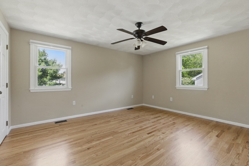 25 Sandra Road Peabody, MA 01960 - Photo 30 of 41 a view of a big room with wooden floor closet and windows