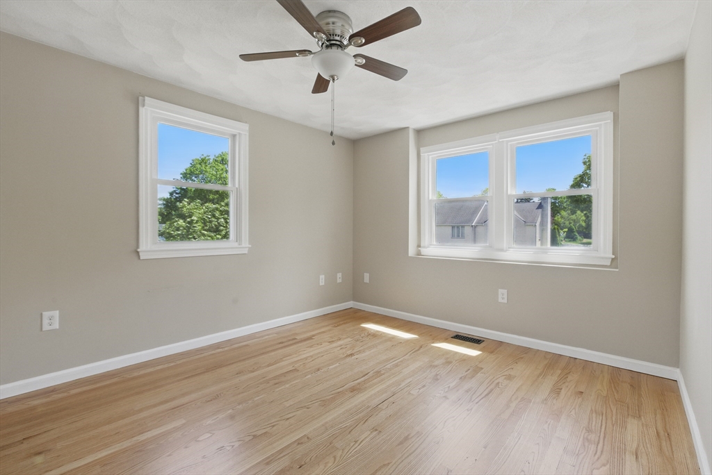 25 Sandra Road Peabody, MA 01960 - Photo 32 of 41 a view of an empty room with wooden floor and a window