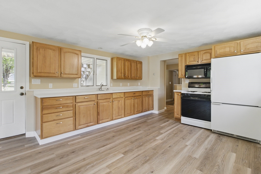 25 Sandra Road Peabody, MA 01960 - Photo 4 of 41 a kitchen with a refrigerator cabinets and wooden floor
