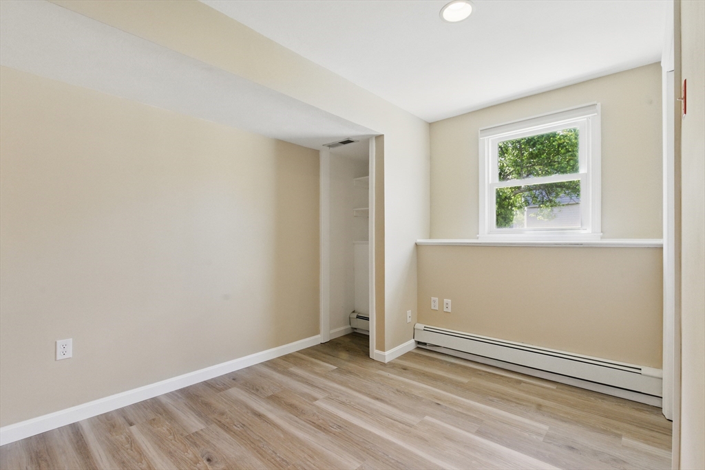 25 Sandra Road Peabody, MA 01960 - Photo 9 of 41 an empty room with wooden floor and windows