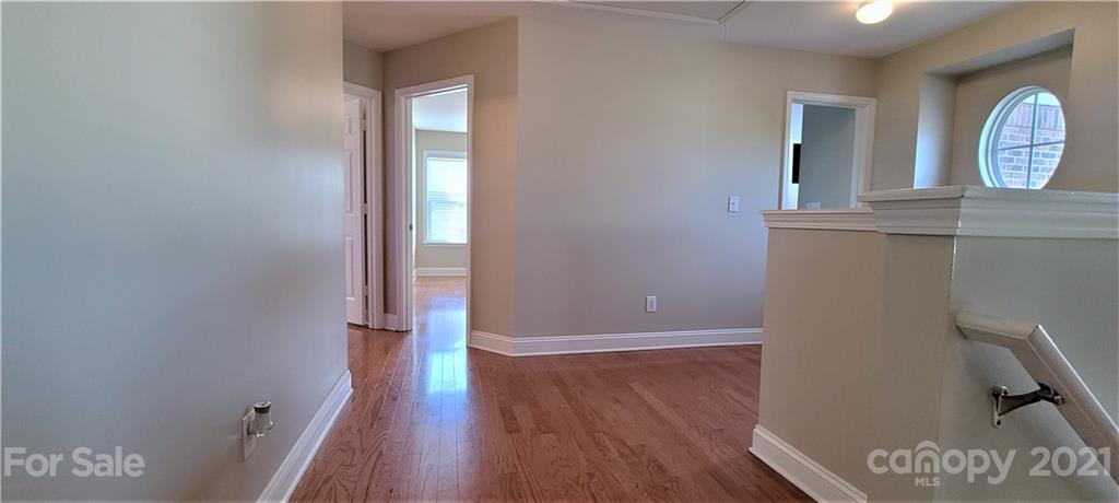 9611 Seamill Road Charlotte, NC 28278 - Photo 11 of 26 a view of a hallway with wooden floor and a bathroom