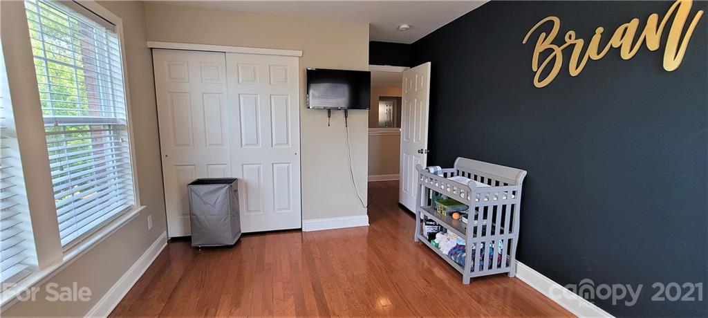 9611 Seamill Road Charlotte, NC 28278 - Photo 16 of 26 a hallway with front door wooden floor and a window