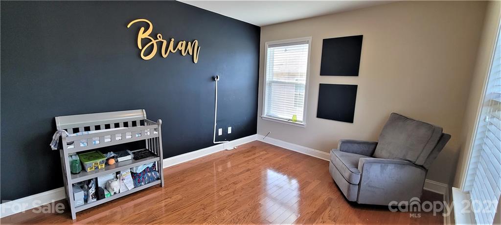 9611 Seamill Road Charlotte, NC 28278 - Photo 17 of 26 a bedroom with furniture and a book shelf