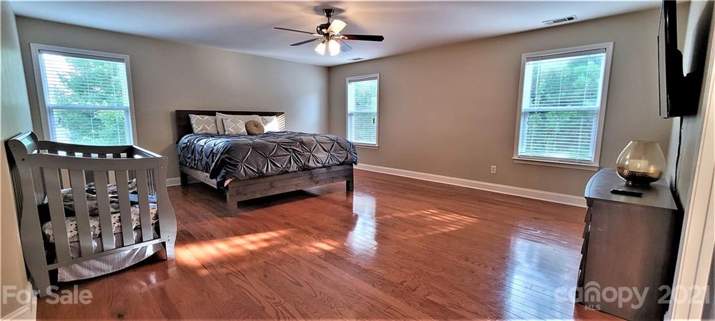 9611 Seamill Road Charlotte, NC 28278 - Photo 20 of 26 a bedroom with furniture and wooden floor