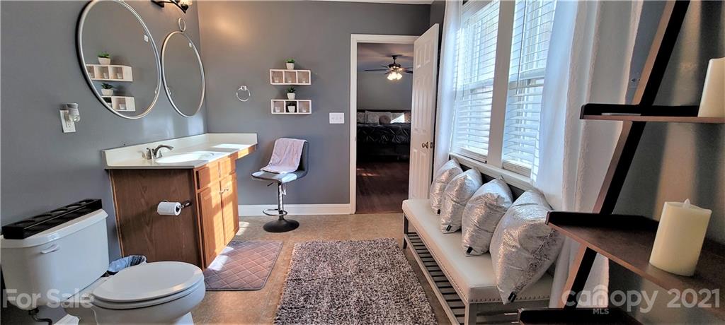 9611 Seamill Road Charlotte, NC 28278 - Photo 22 of 26 a bathroom with a toilet a sink and a mirror