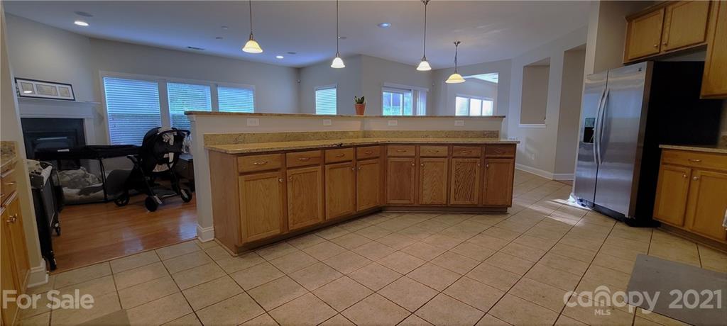 9611 Seamill Road Charlotte, NC 28278 - Photo 5 of 26 a kitchen with kitchen island granite countertop a cabinets a sink and a counter top space