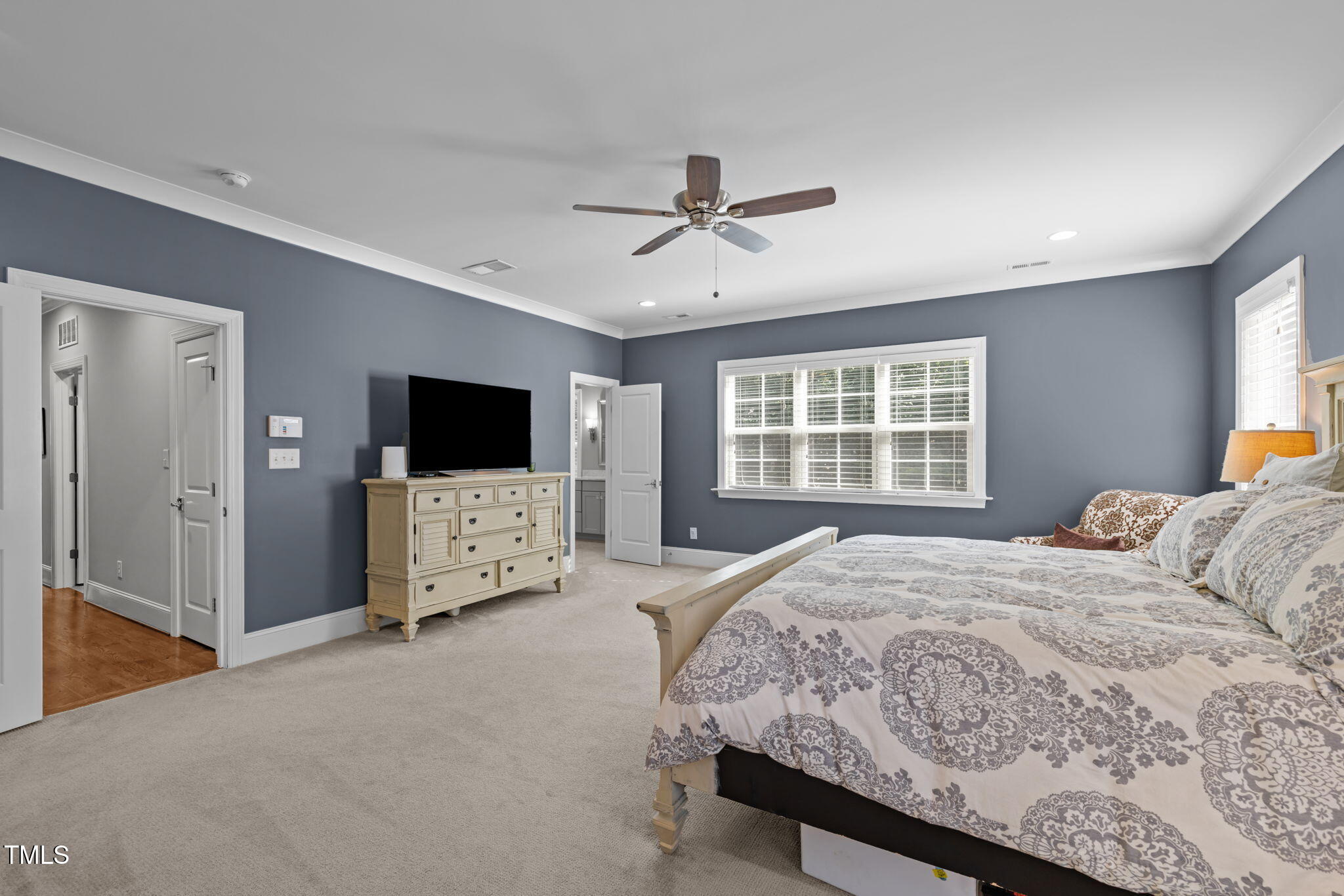 3005 Club Drive Raleigh, NC 27613 - Photo 19 of 45 a bedroom with a bed a flat screen tv and a couch