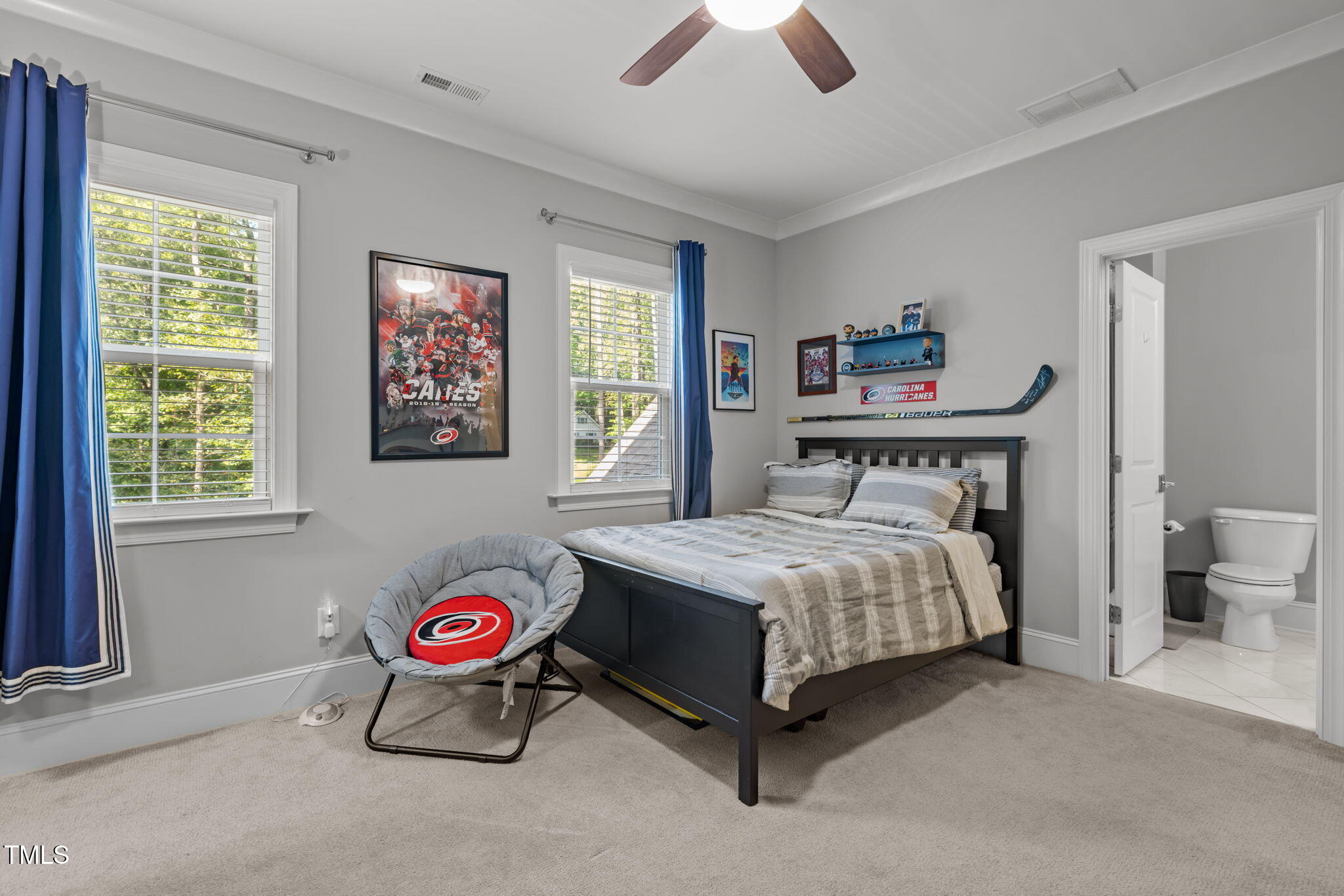 3005 Club Drive Raleigh, NC 27613 - Photo 30 of 45 a bedroom with a bed and a chandelier