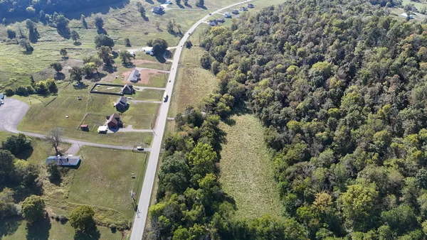 an aerial view of a house with a yard