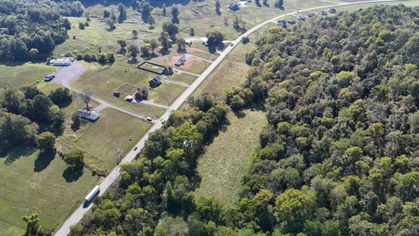 an aerial view of a house with a yard