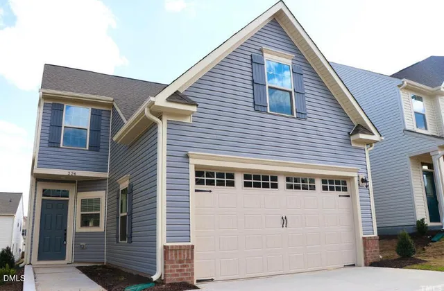 a front view of a house with garage