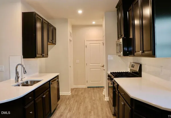a kitchen with a sink and a refrigerator