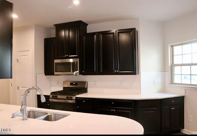 a kitchen with a sink and a microwave