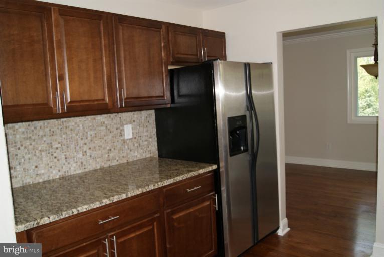 2302 Kingsway Road Fort Washington, MD 20744 - Photo 2 of 30 a kitchen with granite countertop stainless steel appliances and refrigerator