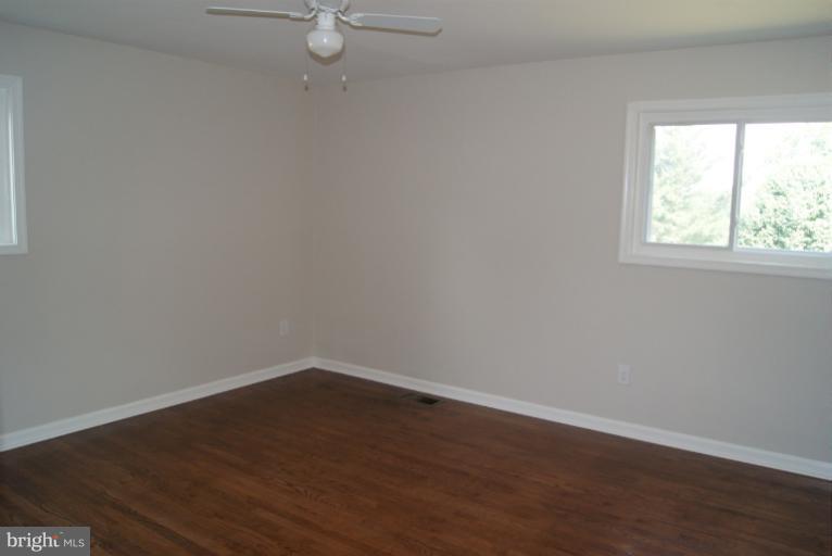 2302 Kingsway Road Fort Washington, MD 20744 - Photo 11 of 30 an empty room with wooden floor and windows