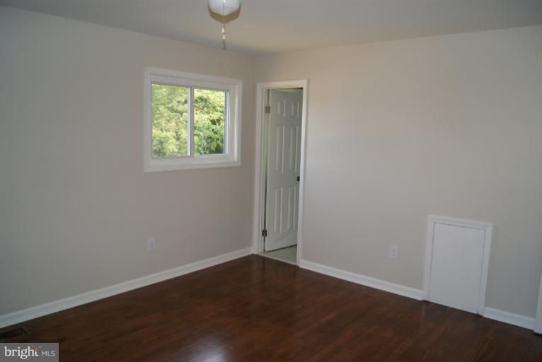 2302 Kingsway Road Fort Washington, MD 20744 - Photo 12 of 30 an empty room with wooden floor and windows