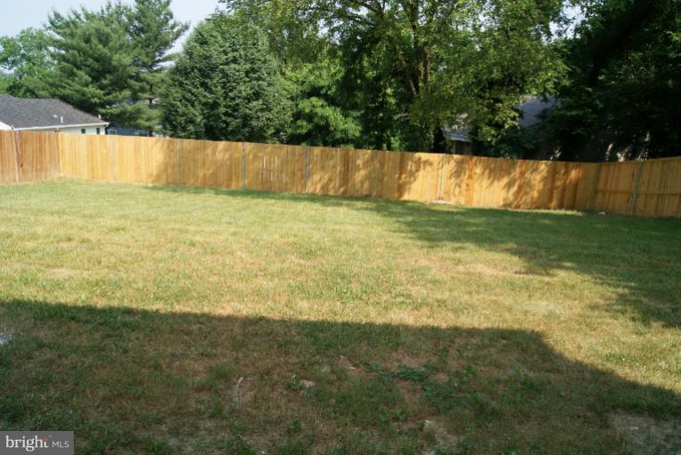 2302 Kingsway Road Fort Washington, MD 20744 - Photo 17 of 30 a view of yard with swimming pool and trees in the background