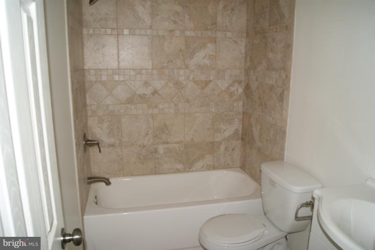 2302 Kingsway Road Fort Washington, MD 20744 - Photo 20 of 30 a bathroom with a toilet and a bathtub
