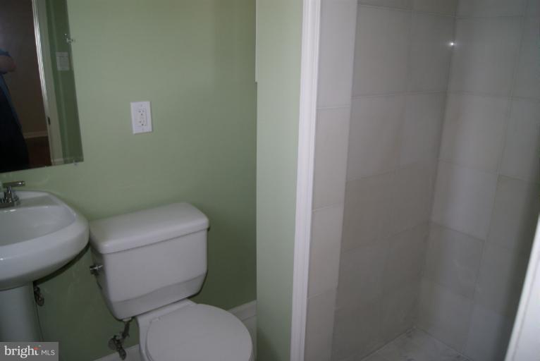 2302 Kingsway Road Fort Washington, MD 20744 - Photo 4 of 30 a white toilet sitting next to a bathroom sink