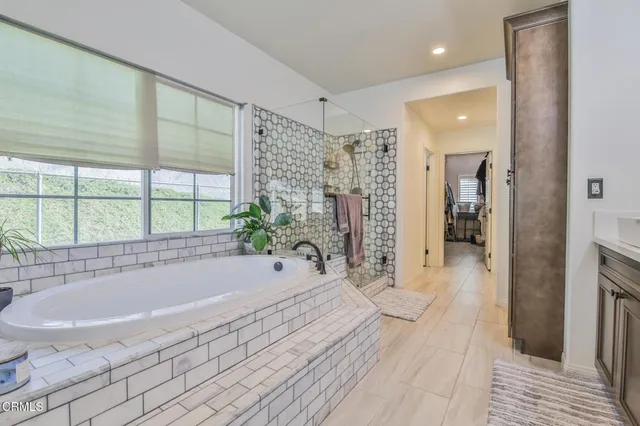 a spacious bathroom with a tub and shower