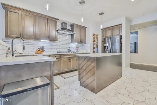 a kitchen with stainless steel appliances granite countertop a sink stove and cabinets
