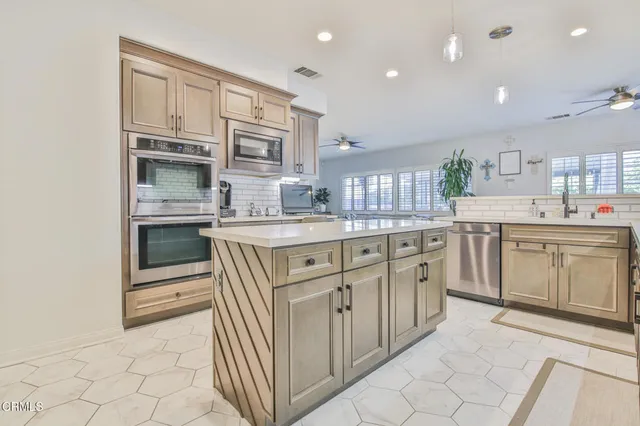 a kitchen with stainless steel appliances granite countertop a sink and cabinets