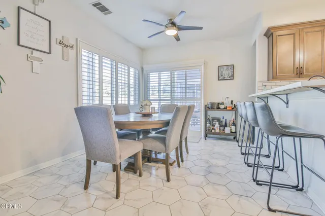 a view of a dining room with furniture and window