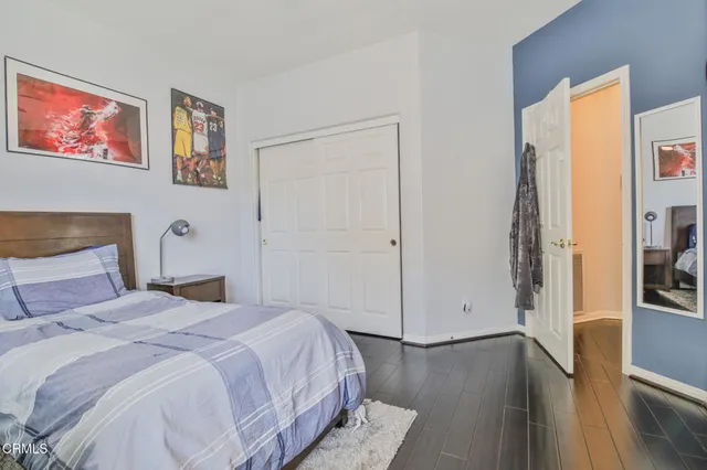 a bedroom with a bed and a painting on the wall