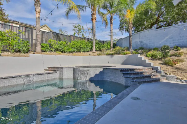 a living room with couches and pool table