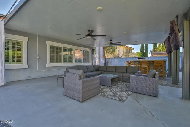 a view of a house with pool and sitting area