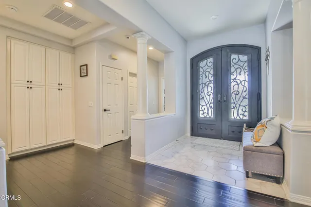 a big room with wooden floor and windows