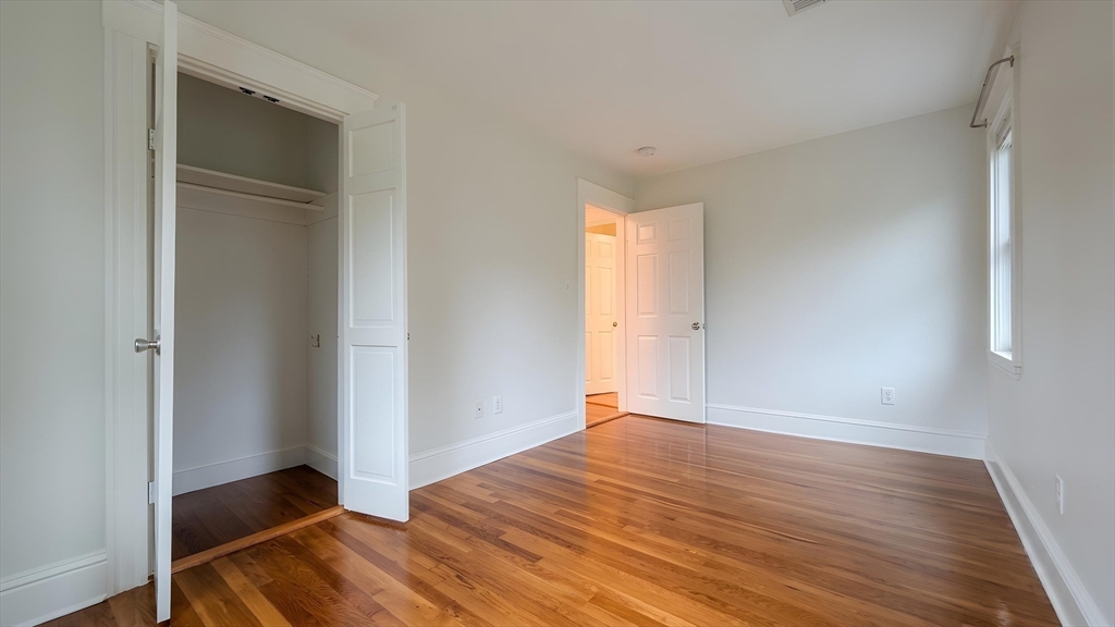 114 Curve Street Dedham, MA 02026 - Photo 16 of 27 a view of an empty room with wooden floor and closet