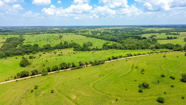 a view of a field with an ocean