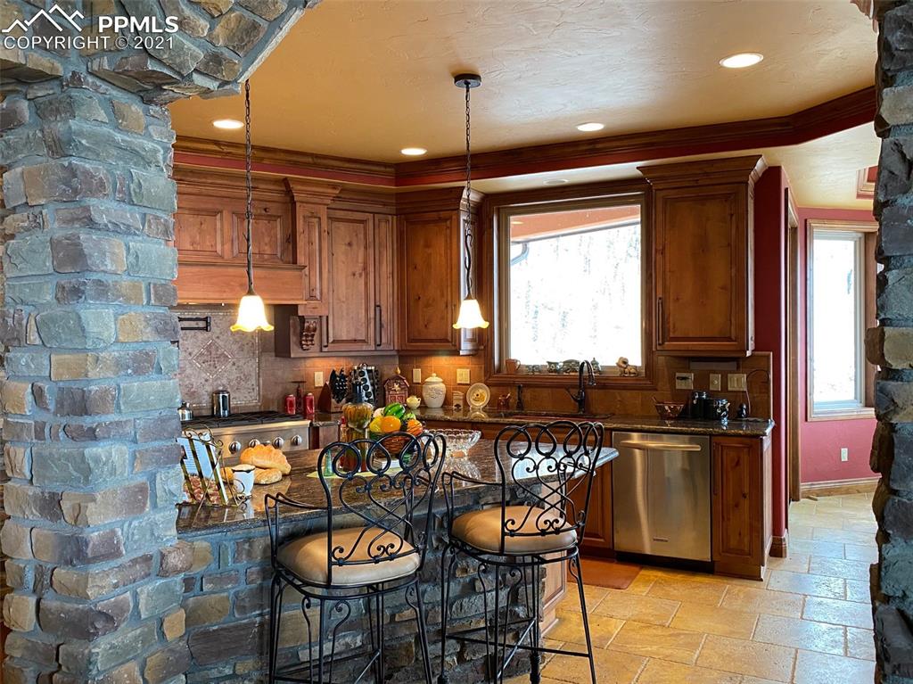 2017 County Road 1 Road Cripple Creek, CO 80813 - Photo 13 of 42 a kitchen with granite countertop a sink and a stove