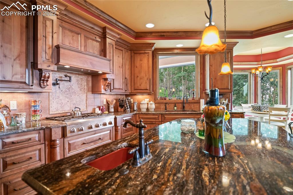 2017 County Road 1 Road Cripple Creek, CO 80813 - Photo 16 of 42 a kitchen with stainless steel appliances granite countertop a stove and cabinets