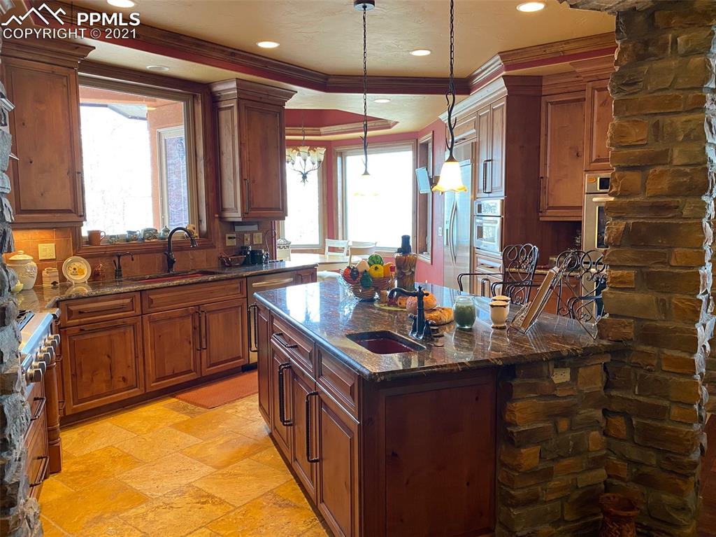 2017 County Road 1 Road Cripple Creek, CO 80813 - Photo 17 of 42 a kitchen with sink a window and chairs