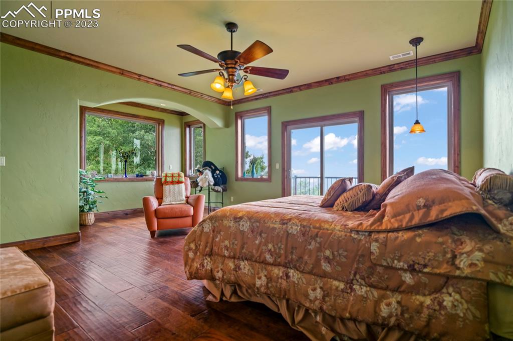 2017 County Road 1 Road Cripple Creek, CO 80813 - Photo 24 of 42 a bed room with a bed and a chandelier