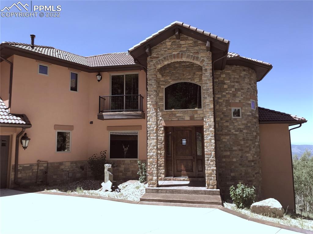2017 County Road 1 Road Cripple Creek, CO 80813 - Photo 5 of 42 a front view of a house with a yard