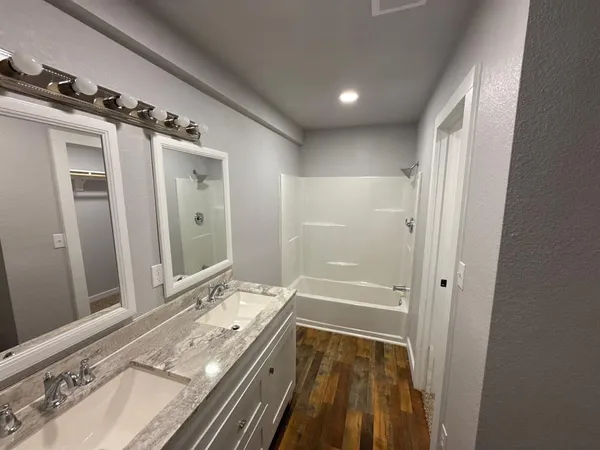 a kitchen with granite countertop a sink and cabinets