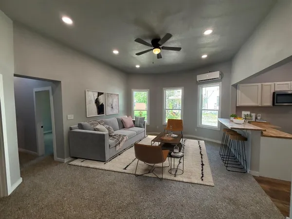 an empty room with windows and closet