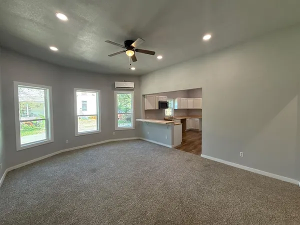 a view of a kitchen with a sink and a ceiling fan