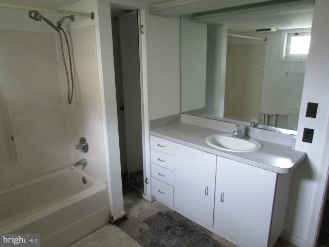 4116 Sampson Road Silver Spring, MD 20906 - Photo 17 of 22 a bathroom with a granite countertop sink two mirror and a bathtub