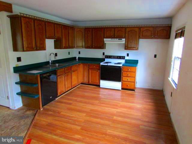 4116 Sampson Road Silver Spring, MD 20906 - Photo 4 of 22 a kitchen with stainless steel appliances granite countertop a stove a sink and a refrigerator